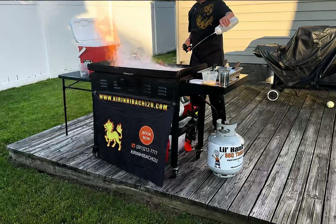 Real Kirin Hibachi Catering portable hibachi grill with towering live flames, branded with the Kirin logo and website